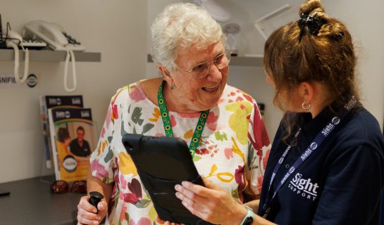 Our Digital Inclusion officer is speaking to a lady, she is holding a tablet and they are deep in coversation